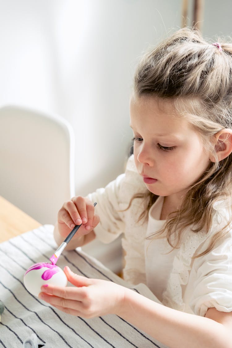 Gentle Girl Painting Egg On Easter Day At Home