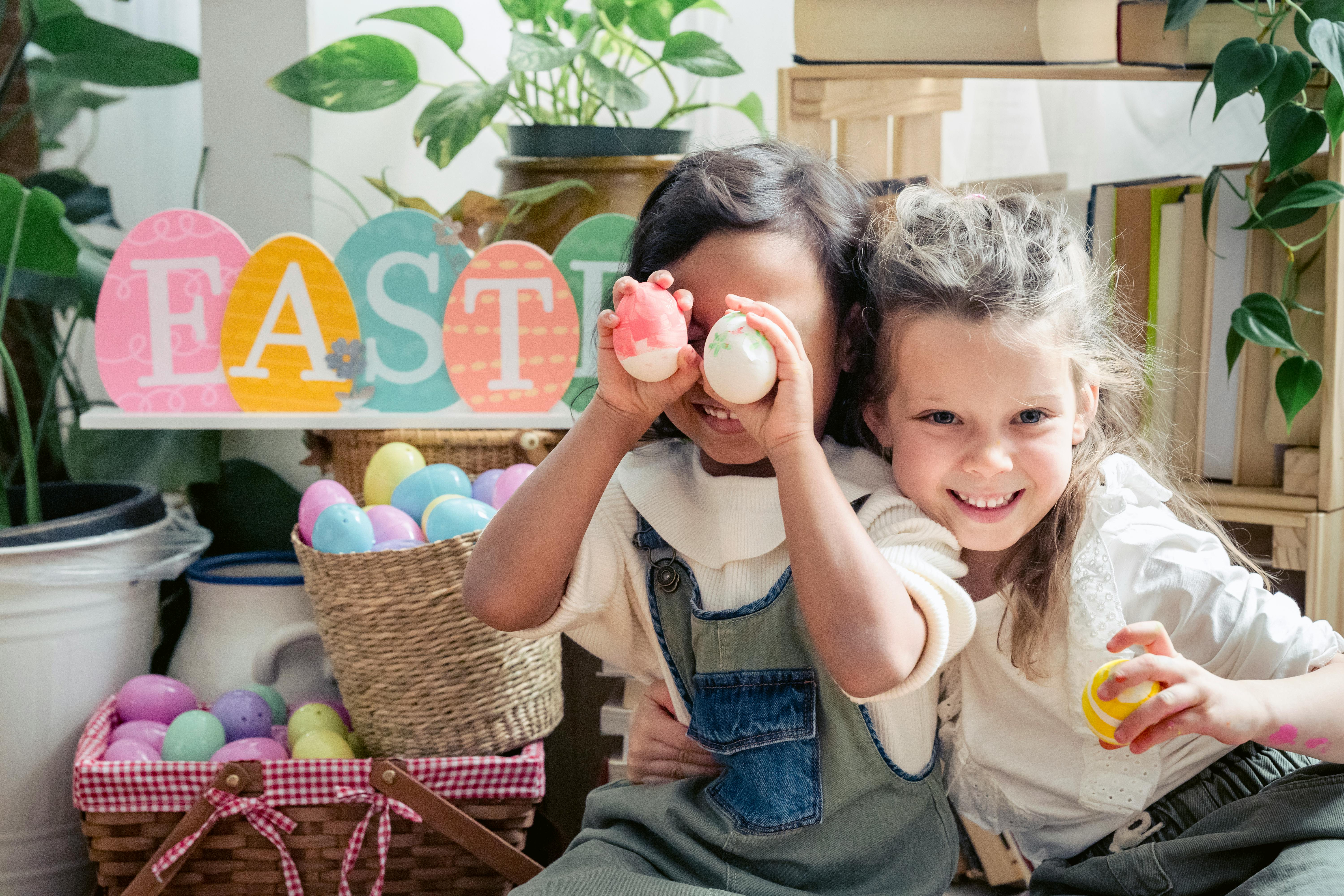 happy multiethnic kids with easter eggs and baskets in house