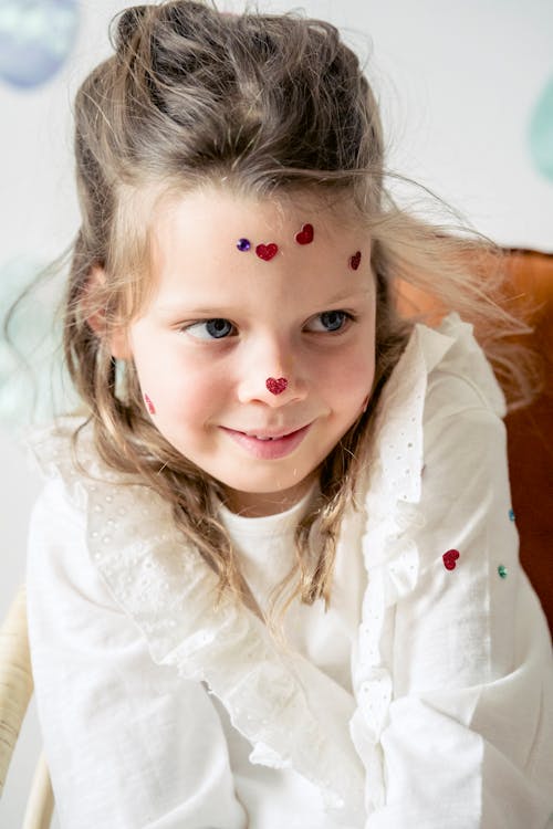 Adorable girl with decoration on face