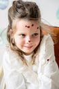 Adorable girl with decoration on face
