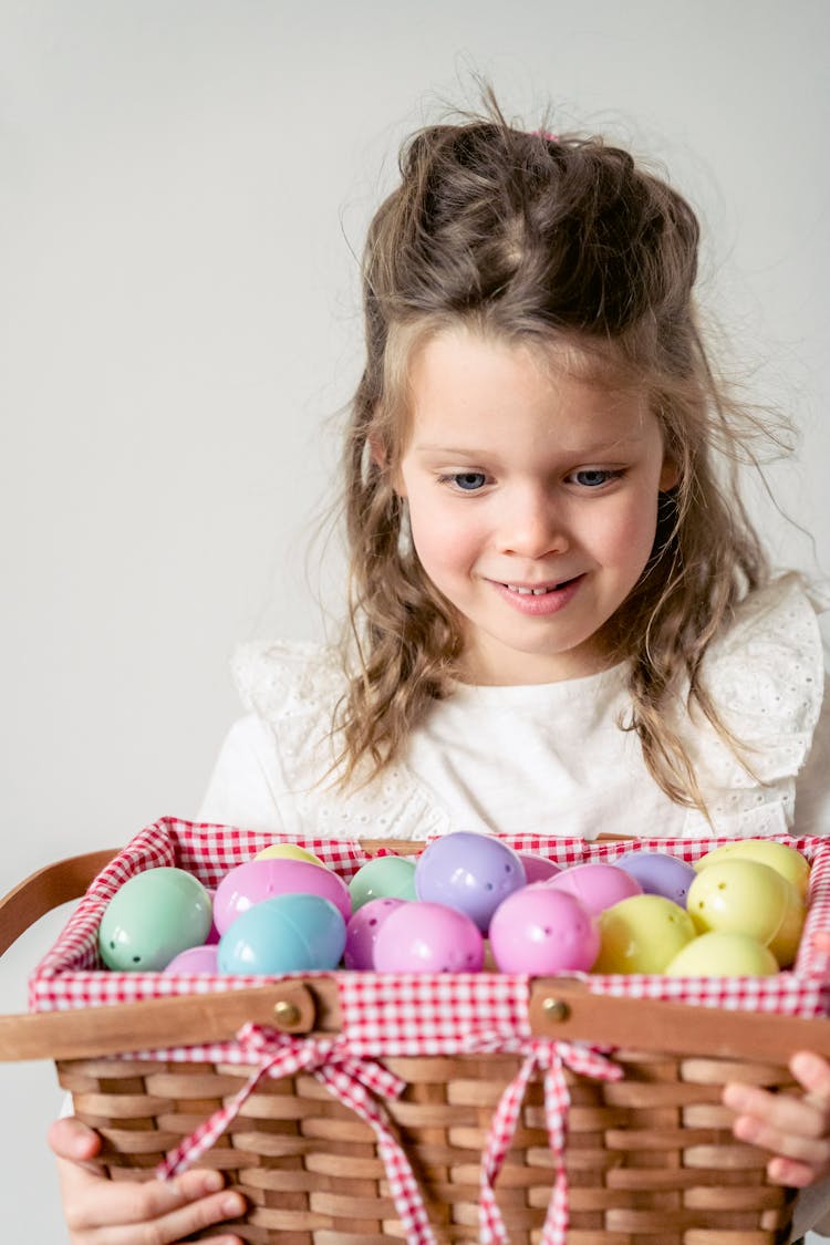 Girl Looking At Colorful Plastic Easter Eggs