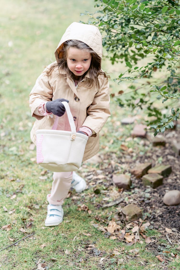 Cute Girl With Toy Bag In Countryside