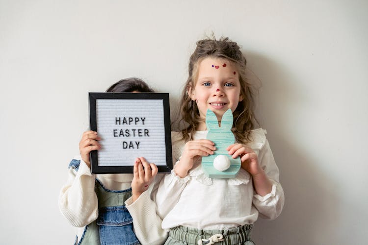 Girls Holding Bunny Silhouette And Happy Easter Card