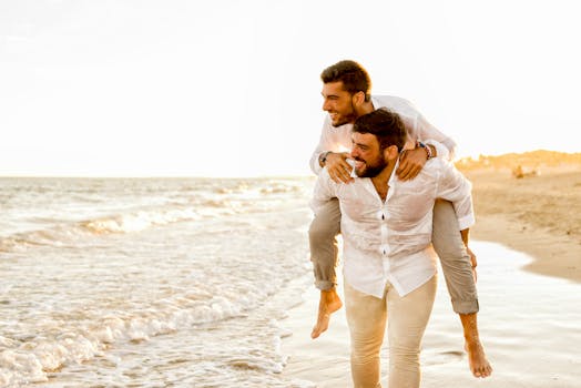 Two joyful men having fun on a beach in Almería, Spain, during a bright sunny day.