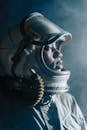 Person Wearing Gray Space Duit and White Helmet