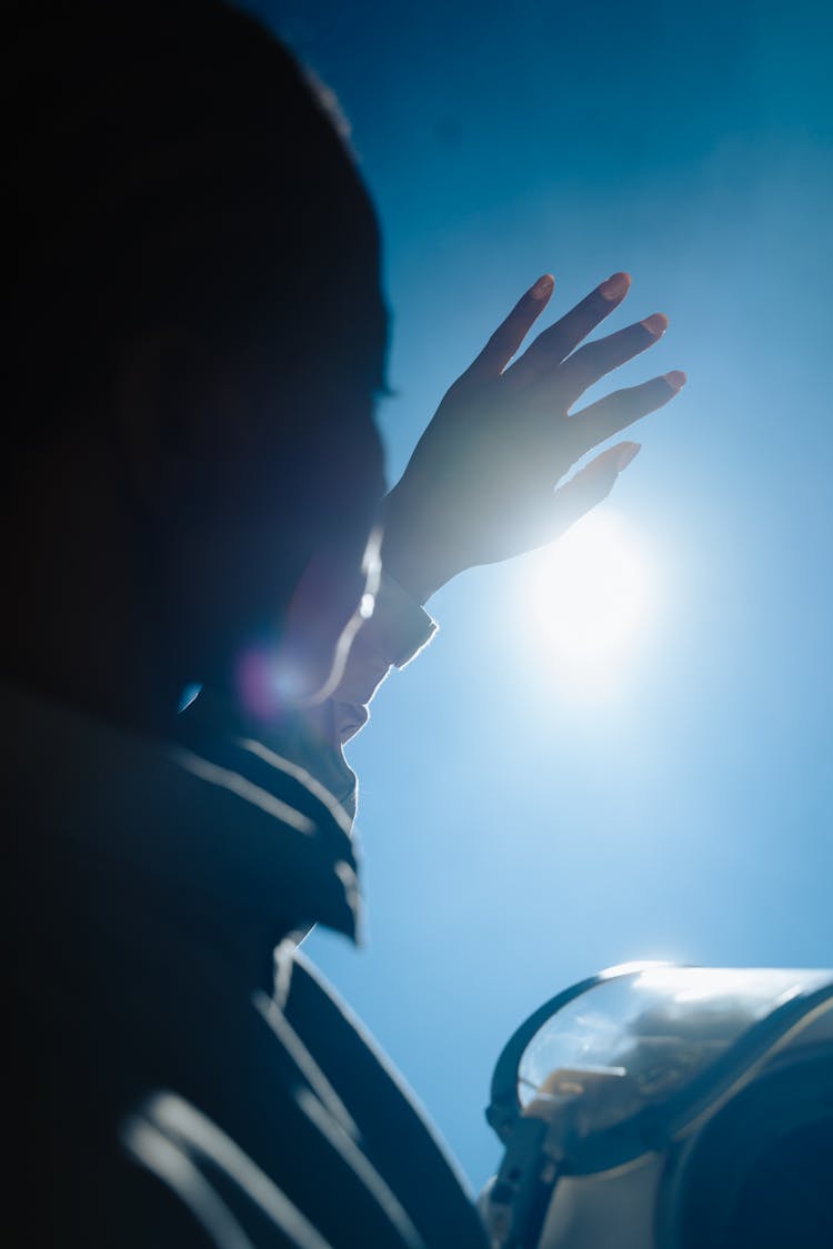 Woman Blocking Light Glare By Hand