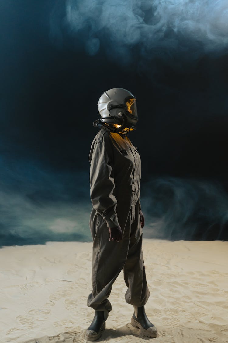 Person In Space Suit With White Helmet Standing In Outer Space