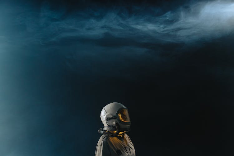 Person Wearing Space Suit And Helmet In Outerspace