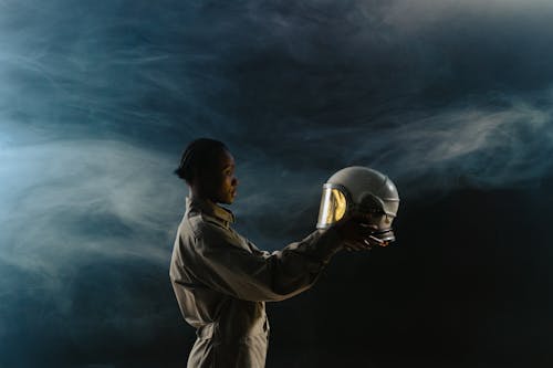 A Female Astronaut Holding a Helmet · Free Stock Photo