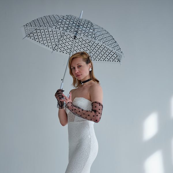 A studio portrait with an open umbrella — photo by Vika Glitter on Pexels