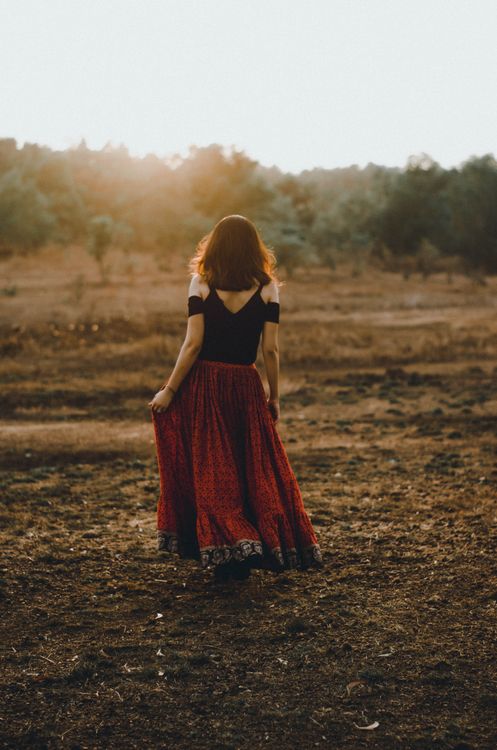 Woman in Black and Red Dress Standing on Dirt Ground · Free Stock Photo