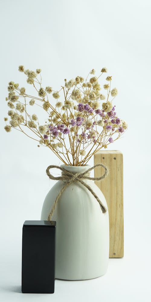 Purple and White Flowers in White Ceramic Vase