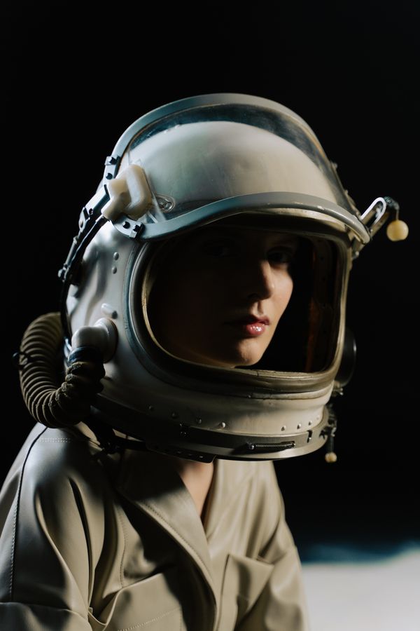 Astronaut in a white helmet against a dark sky — photo by cottonbro studio on Pexels