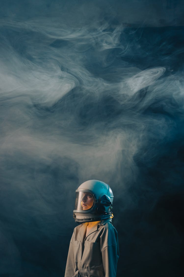 Woman In Brown Spacesuit And White Helmet