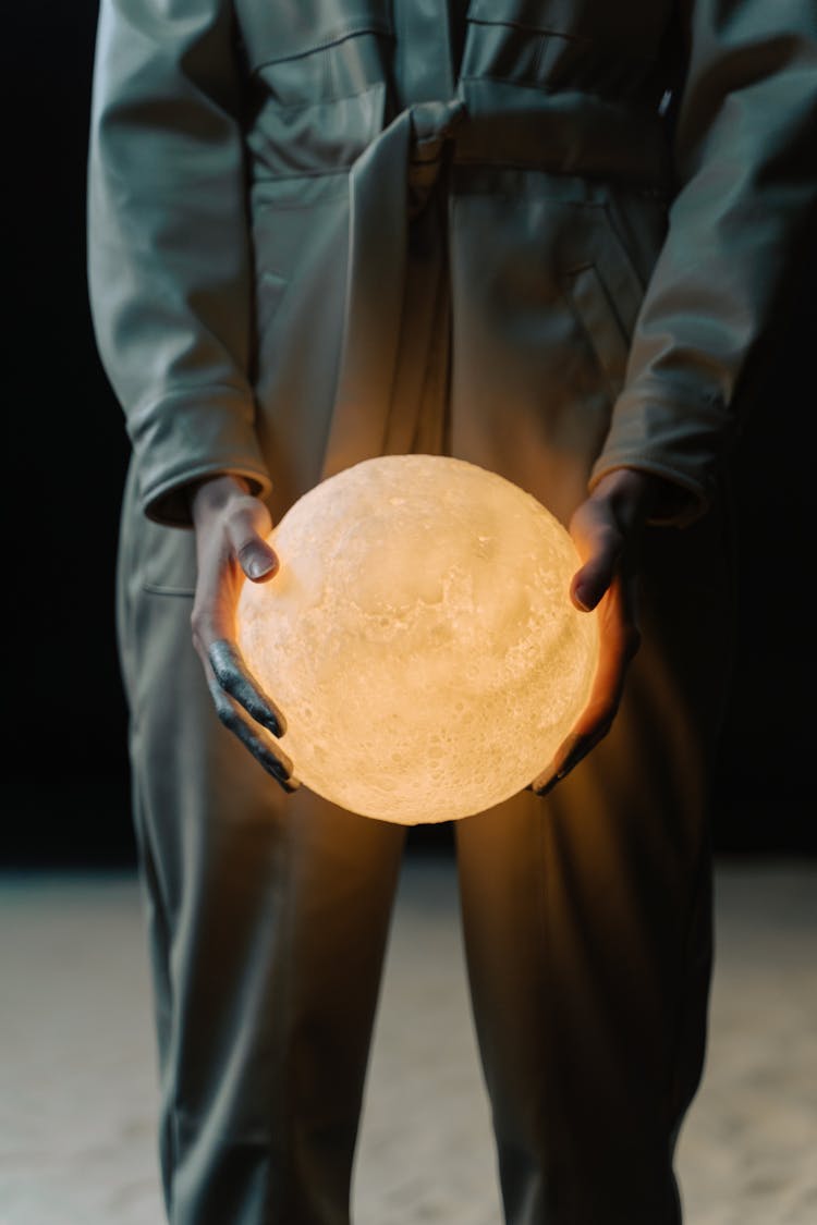 A Person Holding A Light Sphere