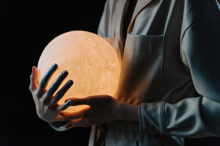 A Person Holding A Light Sphere