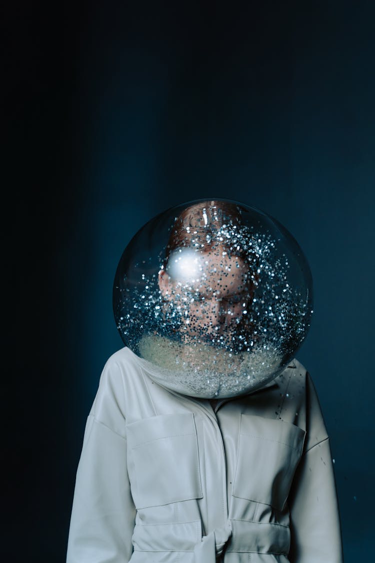 Redhead Woman Wearing Onesie And Transparent Ball With Confetti