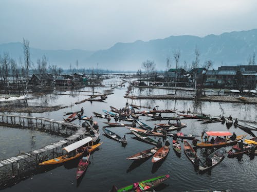 Boats on a River with Mountain Background