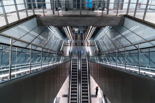 Free A modern metro station interior featuring escalators and glass architecture. Stock Photo