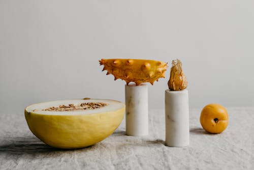 Photograph of a Sliced Horned Melon on Top of a Candle