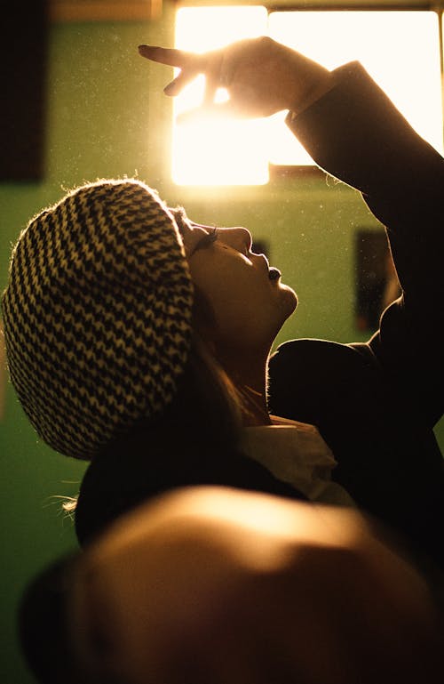 Woman Wearing a Beret with Her Arm Raiseed