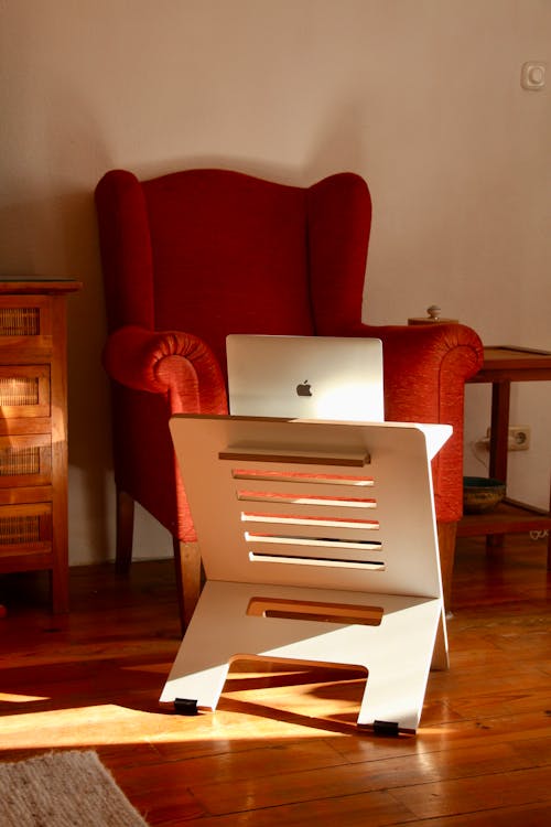 A Red Armchair Near a Laptop