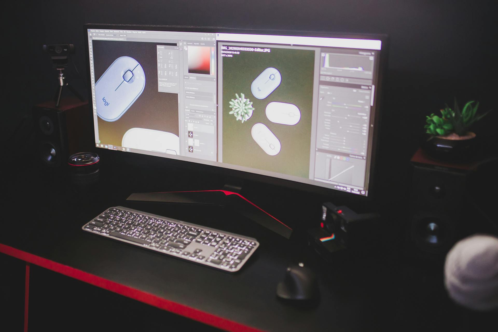 A sleek computer setup with dual monitors, keyboard, and mouse in a dark room.