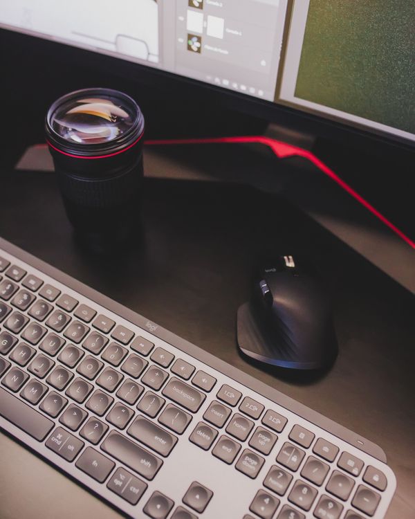 Computer mouse near monitor and camera lens · Free Stock Photo