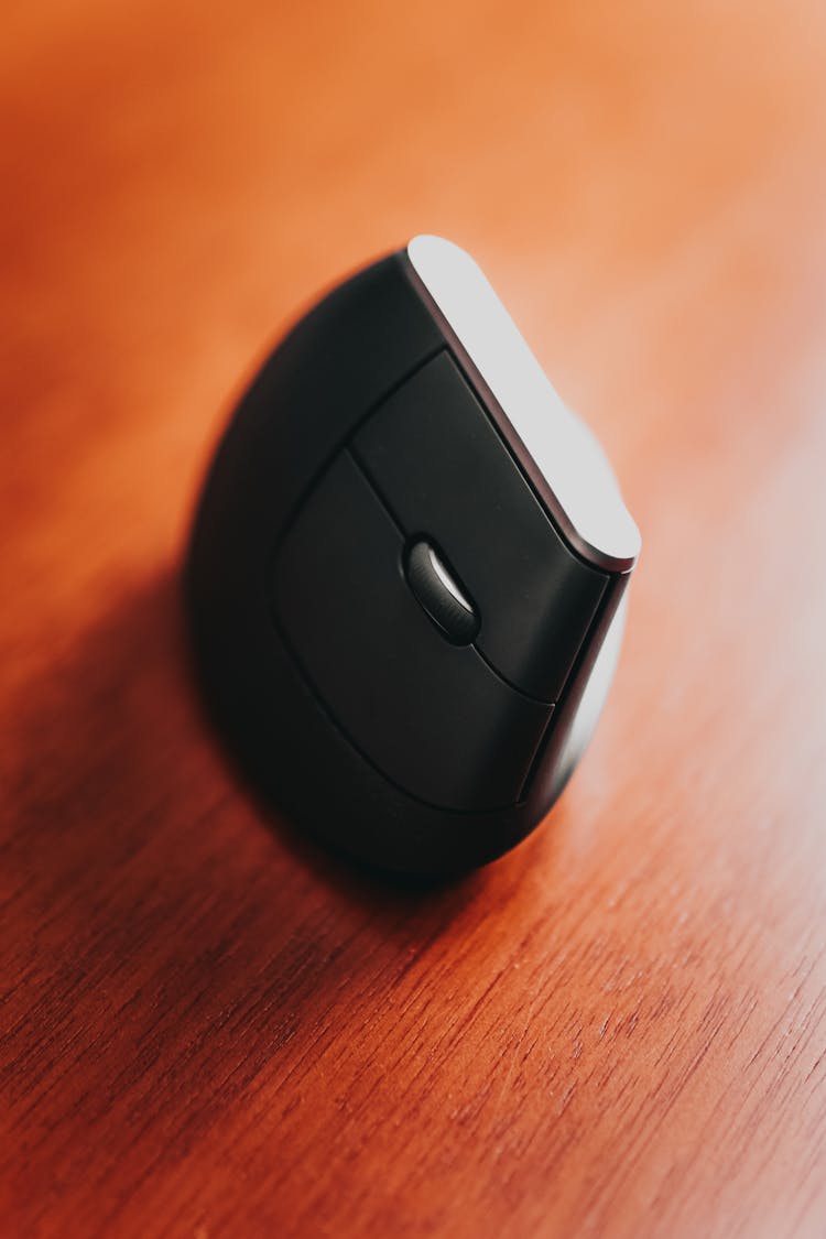 Modern Computer Mouse On Wooden Table