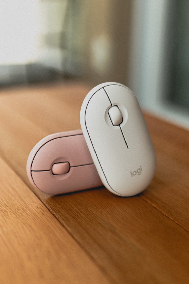 Modern Computer Mice Placed On Wooden Table