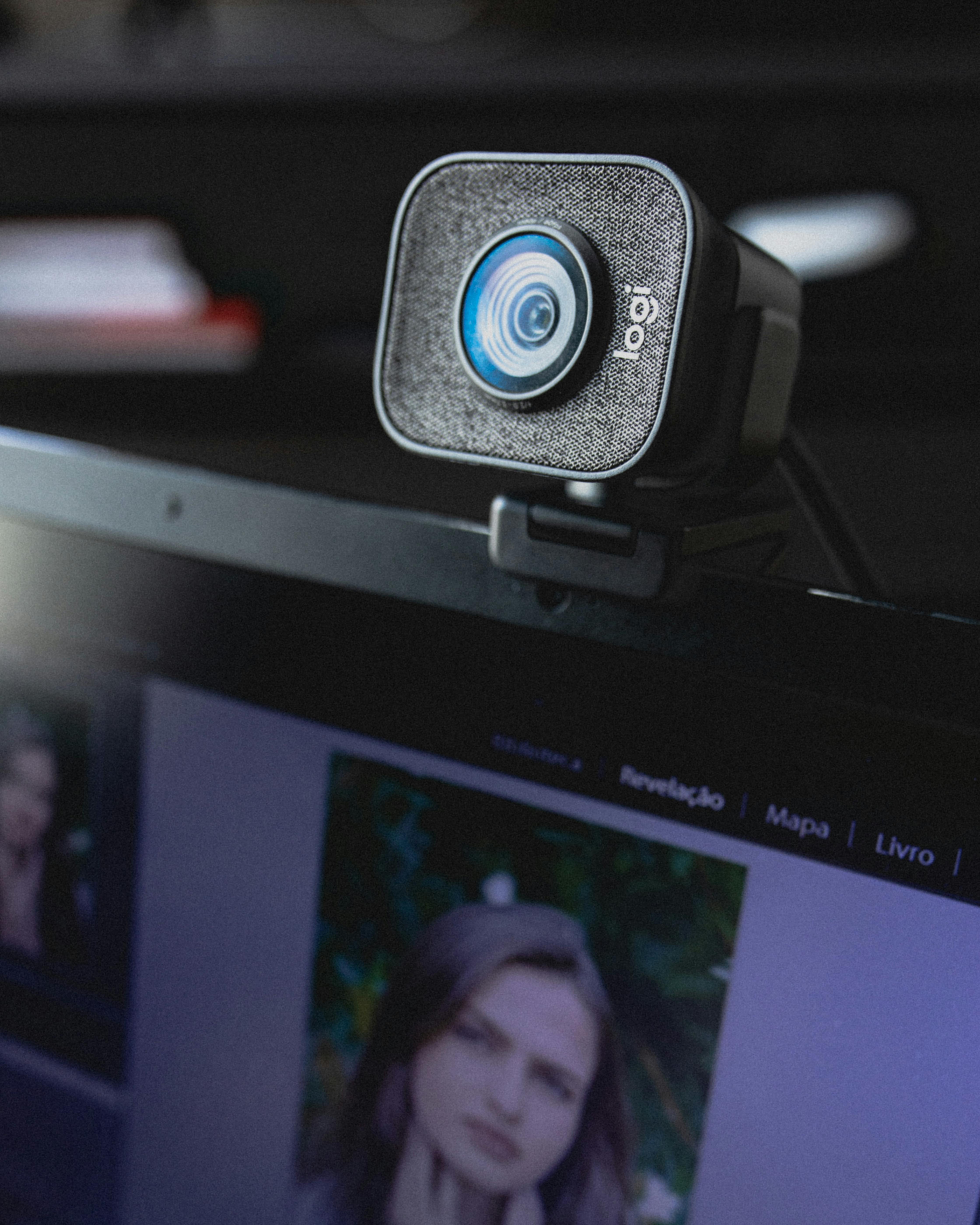 modern video camera hanging on display of laptop