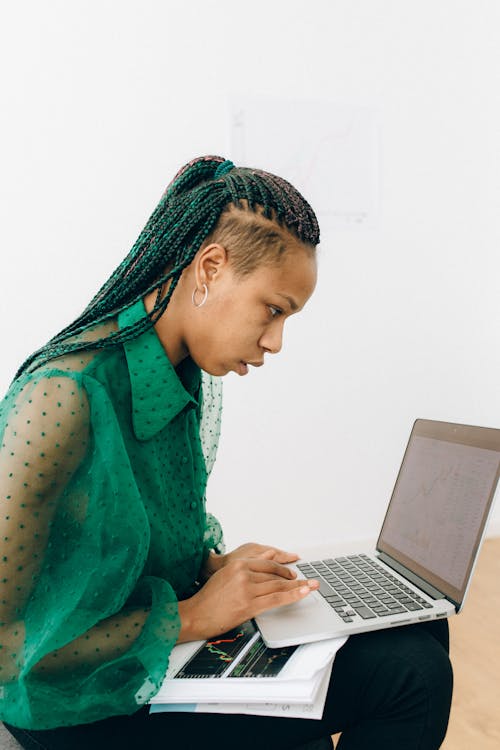 Free Woman in Green Long Sleeve Shirt Using Laptop Stock Photo