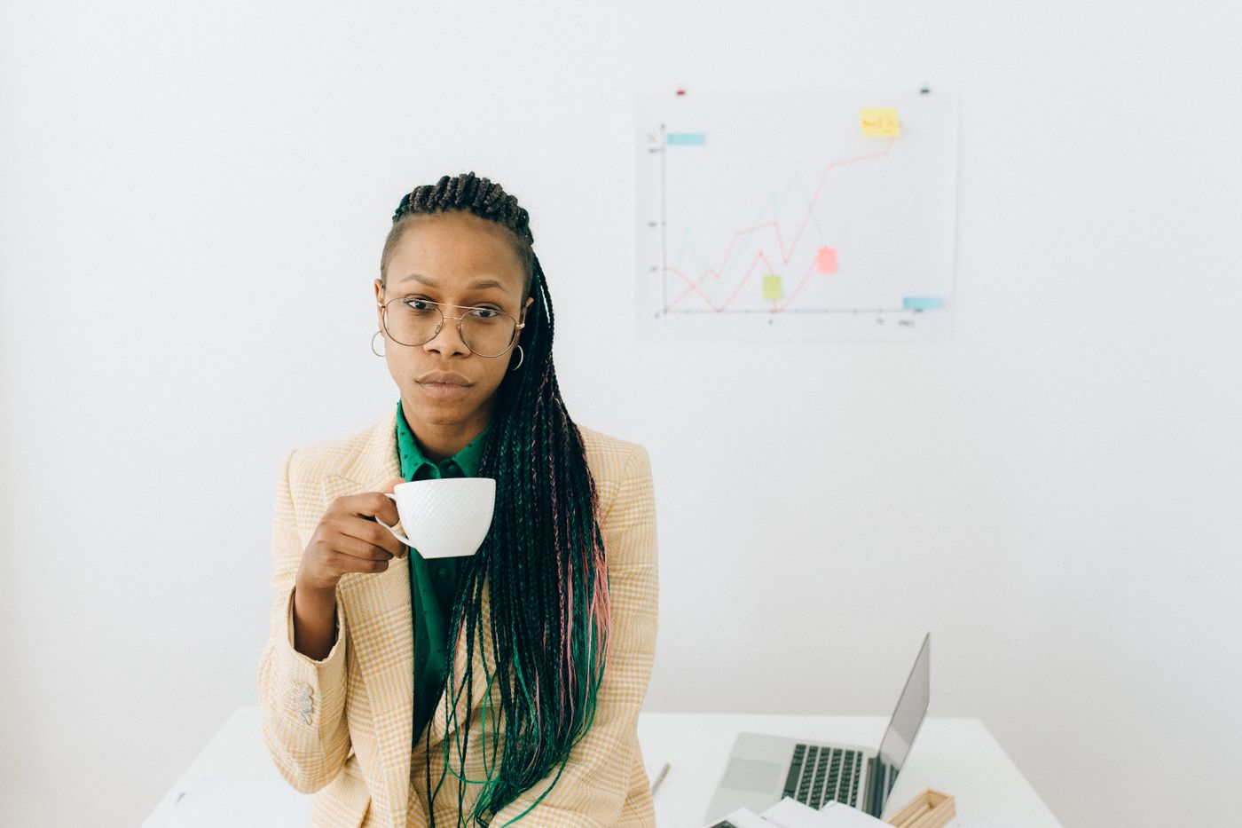 Black businesswoman reviewing credit progress on a laptop