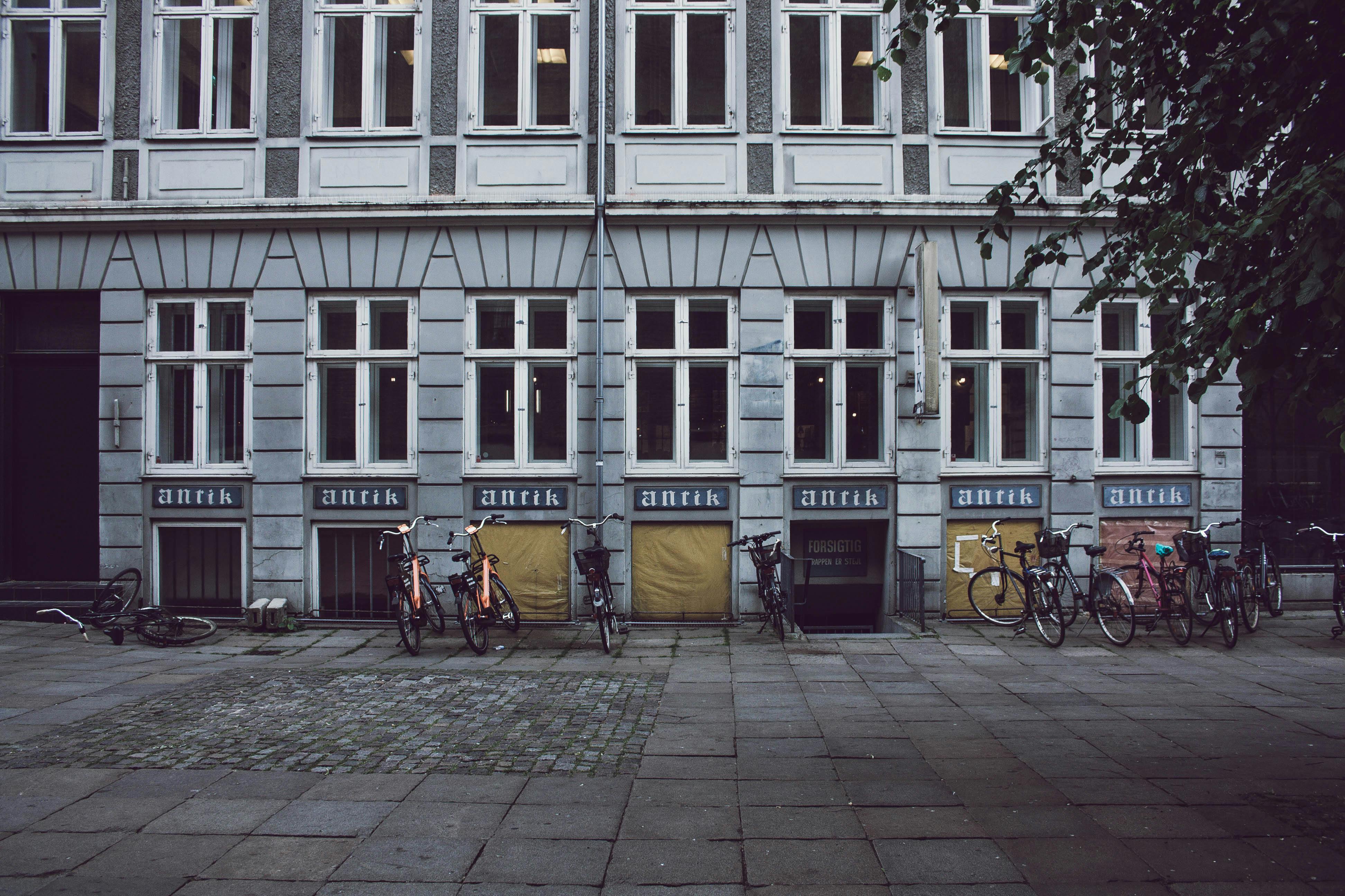Free Bicycles Parked in Front of Building Stock Photo