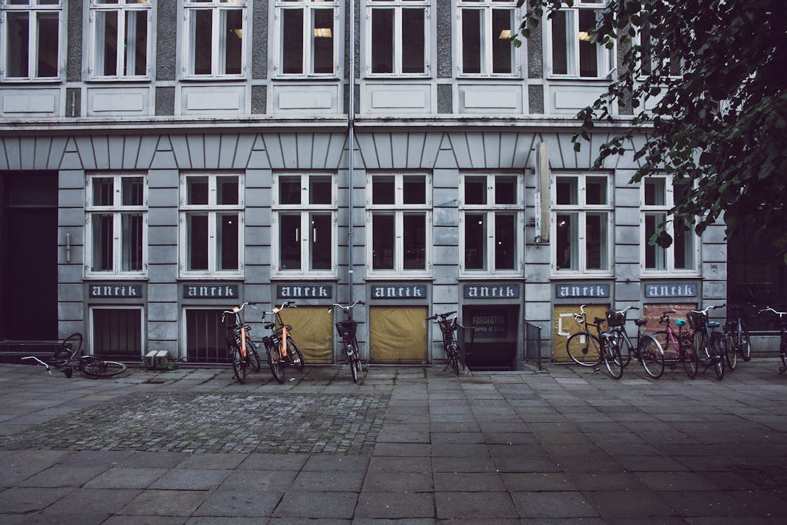 Free Bicycles Parked in Front of Building Stock Photo