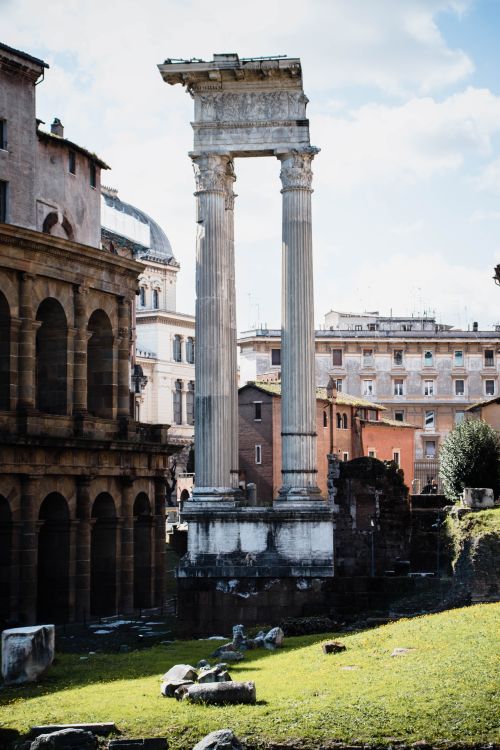 Free Sunlit ruins of ancient Roman architecture with towering columns in Rome, Italy. Stock Photo