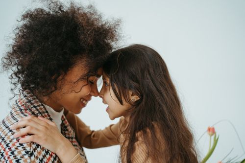 Free Heartwarming portrait of a mother and daughter sharing a joyful embrace, showcasing affection and connection. Stock Photo