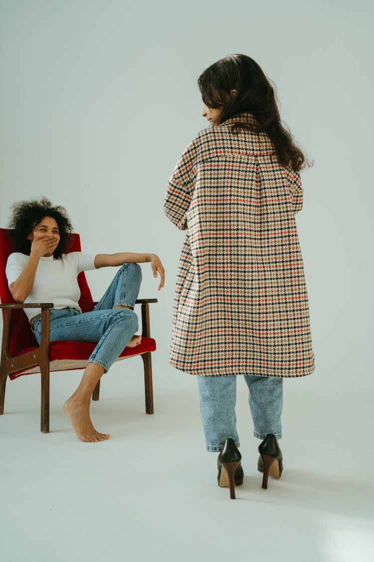 Woman Laughing At The Child Wearing Big Checkered Coat And High Heels Shoes