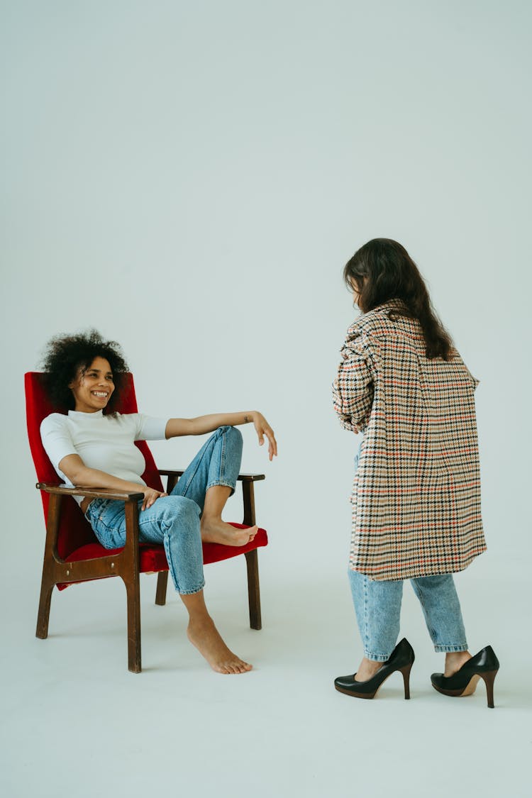 Woman Smiling At The Child Wearing Big Checkered Coat And High Heels Shoes