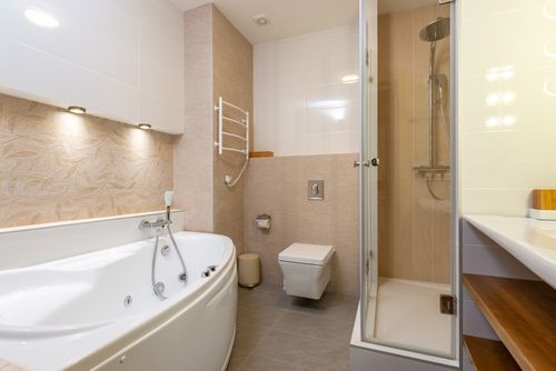 Free A contemporary bathroom featuring a bathtub, shower, and elegant design elements. Stock Photo