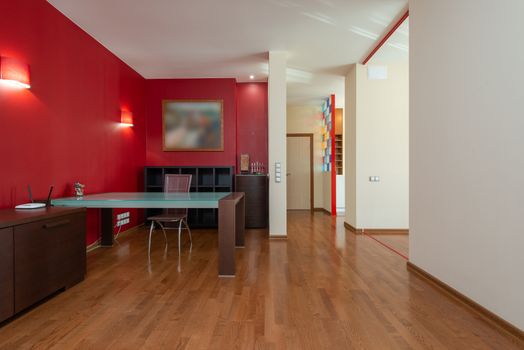 Modern house interior with table and chair near cabinet under lamps next to doorways
