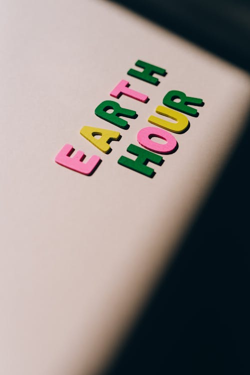 Close-Up Shot of Earth Hour Lettering on a White Surface