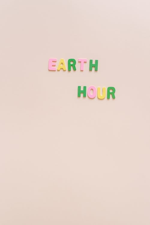 Free Earth Hour Text over Pink Surface Stock Photo