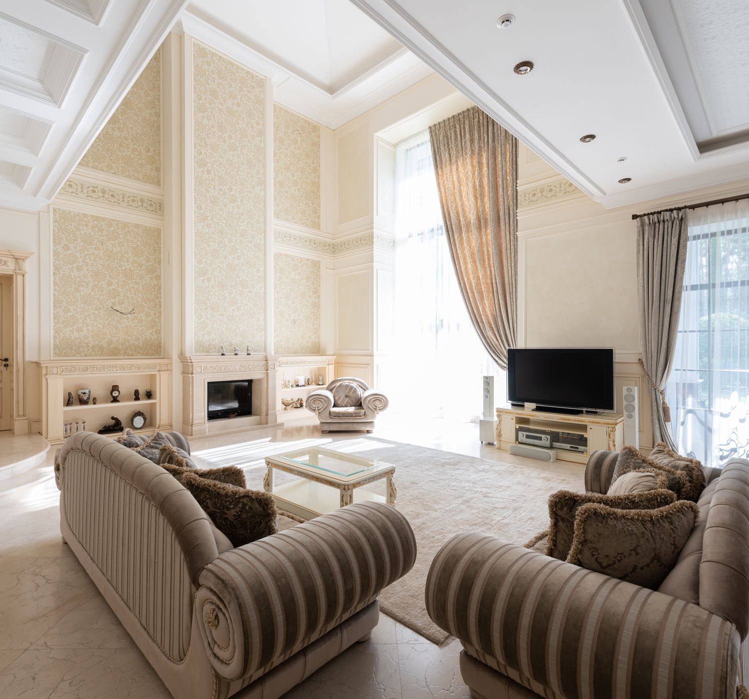 Interior of spacious living room with sofas near table on carpet next to TV and windows wi
