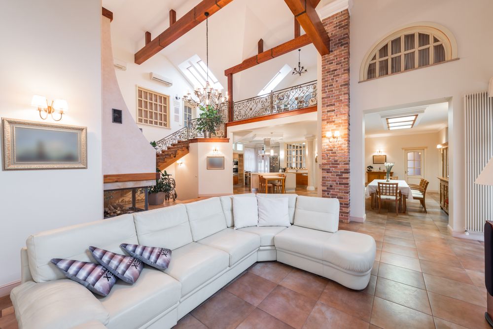 Open living room connected to the kitchen and staircase, prepared for listing photos