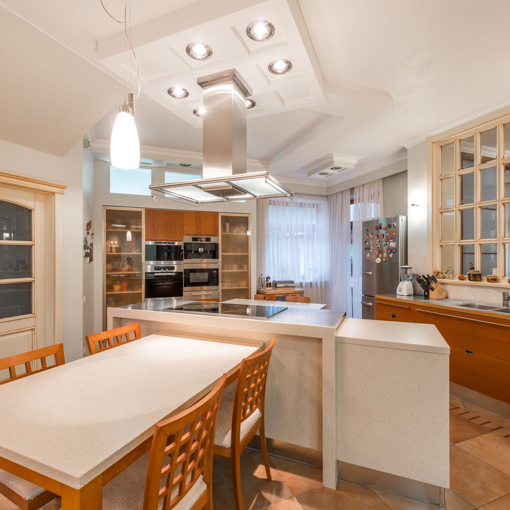 Kitchen Spraying in Newbury Park — a decorator at work mid-project