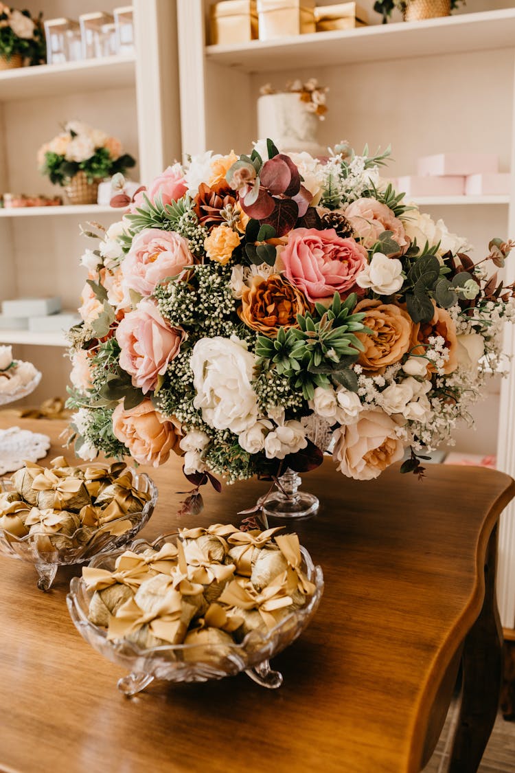 Blooming Flower Bouquet On Table With Cloth Gift Bags Indoors