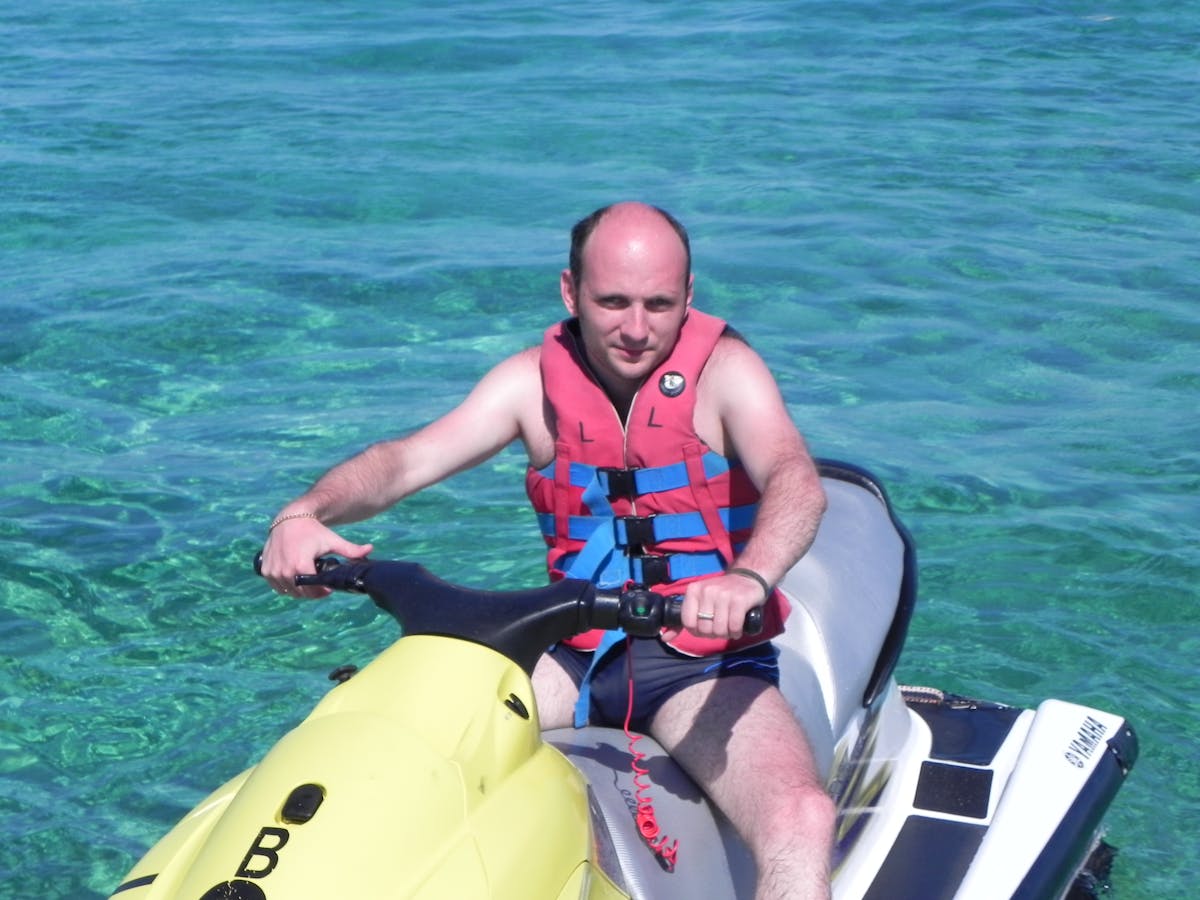 Person making a smoothie with supplements in a modern kitchen