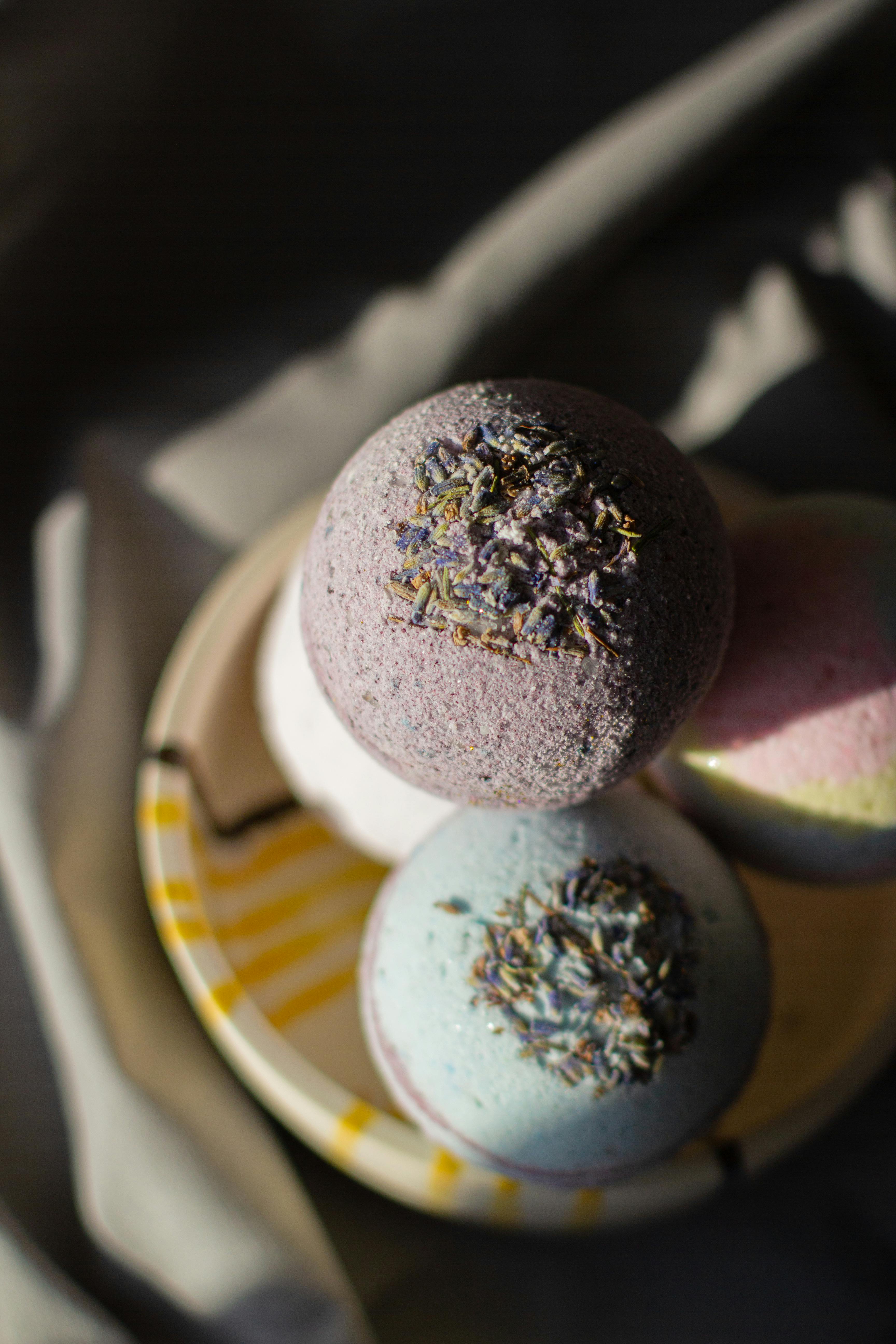 multicolored bath bombs heaped in bowl