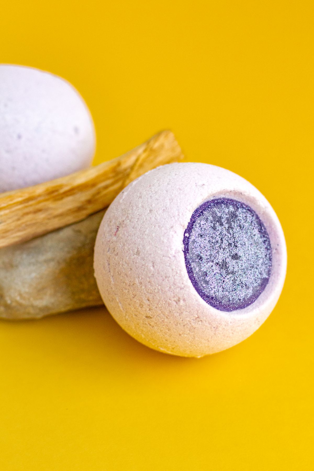 Colourful bath bombs on a yellow background